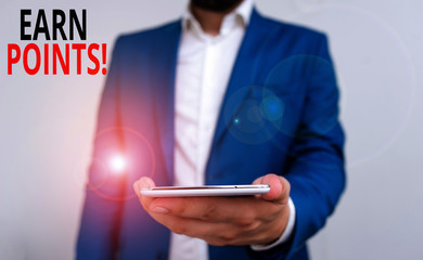 Word writing text Earn Points. Business photo showcasing collecting scores in order qualify to win big prize Business concept with man holding mobile phone with touch screen
