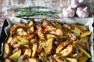 Selective focus. Homemade baked rustic potato with garlic and rosemary.