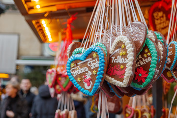 Close up view of gingerbreads with "Frohes Fest" means Merry Celebration  are hang in front of stall shop in Weihnactsmarkt, Christmas Market, in Düsseldorf, Germany.