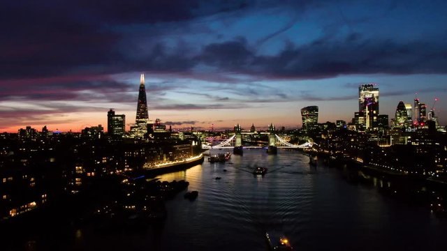 Establishing aerial view of London City Skyline Shard , Thames River and Tower Bridge in foreground, beautiful dusk sky London UK