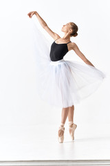 Naklejka premium young ballet dancer posing in studio