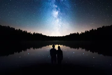  Romantic Couple Standing Under The Starry Sky, Milky Way Reflects Off Lake © Filip