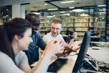 Multiracial group cooperating for project in library