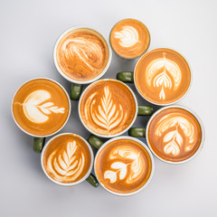 many coffee latte cup on white background, top view