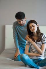 young couple sitting on sofa and looking at each other