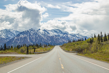Fototapeta premium Scenic road heading toward mountains in Alaska