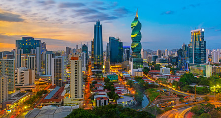 The colorful panoramic skyline of Panama City at sunset with high rise skyscrapers, Panama, Central America. - Powered by Adobe