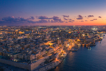 Fototapeta premium Aerial view of Valletta, Malta with Basilica of Our Lady of Mount Carmel at sunset