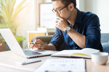 hand holding using texting cell phone and typing computer.businessman at workplace Thinking investment plan.chatting contact Investor.searching for information use internet.connecting people concept