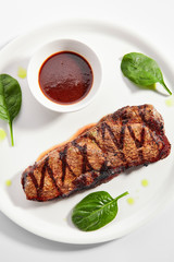 Striploin steak with sauce close up