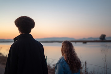 Young Man and Woman Looking to Sunset
