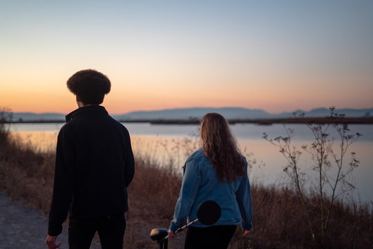 Young Man And Woman With Metal Detector