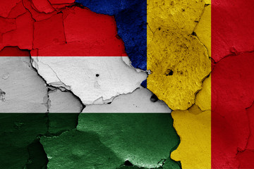 flags of Hungary and Romania painted on cracked wall