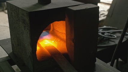 Forge workshop. Smithy manual production. Gas furnace for heating metal. Modern melting stove for...