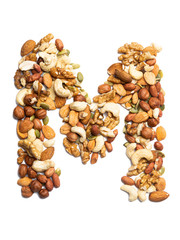 Letter M of the English alphabet from a mixture of hazelnuts, almonds, walnuts, peanuts, cashews, pumpkin seeds on a white isolated background. Food pattern made from nuts. Bright alphabet for shops.