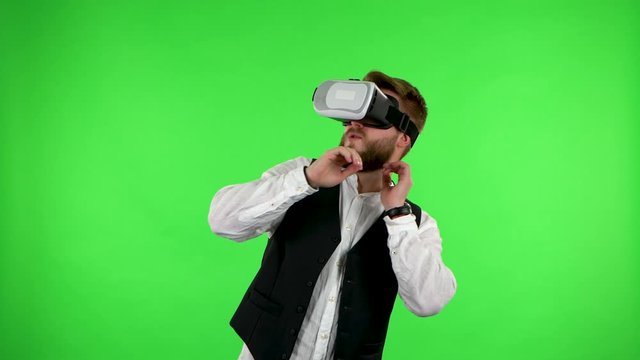 Man with virtual reality headset or 3d glasses. Green screen