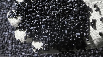 Plastic black gray granulated crumb. Manufacture of plastic water pipes of the factory. Process of...