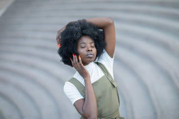 Young and beautiful black girl on an urban landscape, creative fashion shot, stairs.