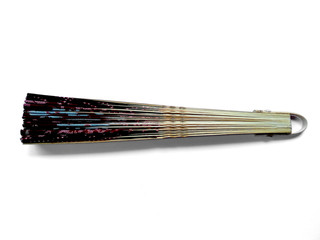 Fototapeta premium Hand fan from Bali Indonesia. Kipas Tangan Motif Batik or hand fan Batik made of bamboo and batik fabric. Hand fan patterned batik isolated on white background.