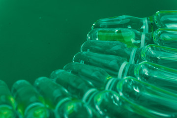 Glass medical ampoule vial for injection. Medicine is liquid sodium chloride with of aqueous solution in ampulla. Close up. Bottles ampule multicolor on background color and water. Human plasma.