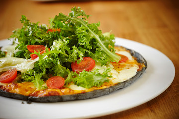 Black dough salad pizza with black pepper 