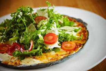 Black dough salad pizza with black pepper 
