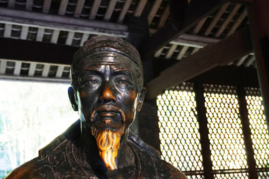 A brass statue of Du Fu at the entrance of Dufu thatched Cottage. Du Fu was a prominent Chinese poet of the Tang dynasty.