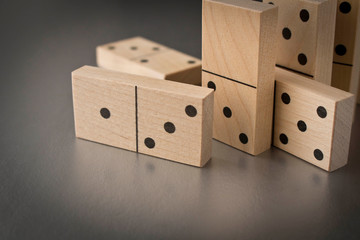Playing dominoes on a silver background. Leisure games concept. Domino effect.