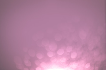 Pink Festive Christmas Beautiful abstract Background with bokeh lights. Holiday Texture with copy space. Can be used as Wallpaper, filling for a website, defocused