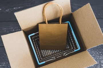 shopping basket and bag inside open delivery parcel