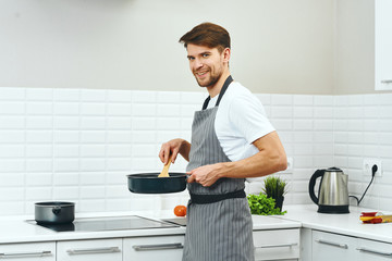 man cooking in kitchen