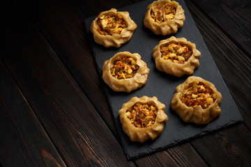 Dumplings with vegetable: Dimsum, Jiaozi, Momo, Ha Gao on dark wood background.