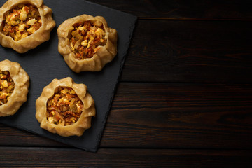 Dumplings with vegetable: Dimsum, Jiaozi, Momo, Ha Gao on dark wood background. Top view