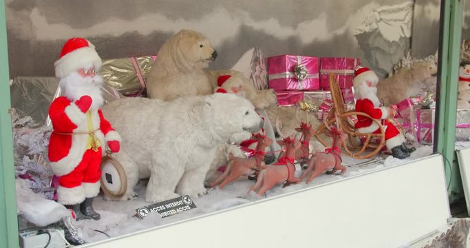 Steady shot of animatronics at the Christmas Market, Paris (Tuileries), France. Beautiful animal figures (penguin, polar bear), Santa Klaus & presents & a female snowman. Chilling in the fake snow.