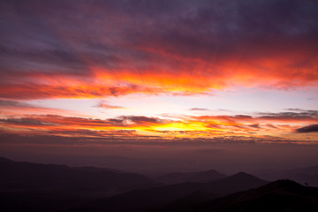 colorful clouds in sky on sunrise mountains