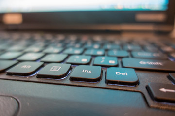 Fototapeta na wymiar Black backlit keyboard for laptop computer macro close up.