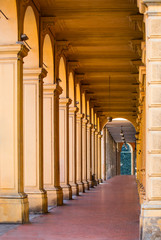 Narrow city street view traditional architectural features in Bologna, Italy