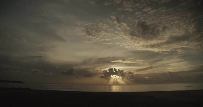 Epic scenery of the sun rays in the clouds while the sun sets on the Icacos wetlands on the Caribbean island of Trinidad and Tobago