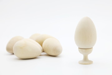 Decorative chicken eggs made of natural wood made by hand.The concept of the Christian Easter tradition is to creatively decorate and color artistically a bunch of eggs for a gift.
