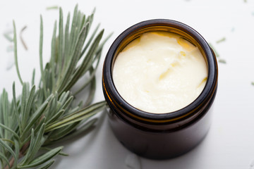 shea butter in brown glass pot and lavender leaves