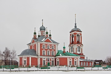 Fototapeta na wymiar Beautiful Church of the forty martyrs with Belltower on shore of Plescheevo lake in Pereslavl-Zalessky, Russian Golden Ring Landmark in winter day