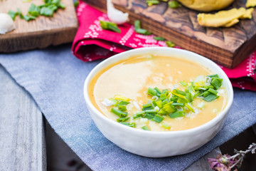 Peas soup. Hot yellow creamy homemade soup with peas and green onion sprouts on winter Christmas or Xmas background. Vegan and vegetarian food. 