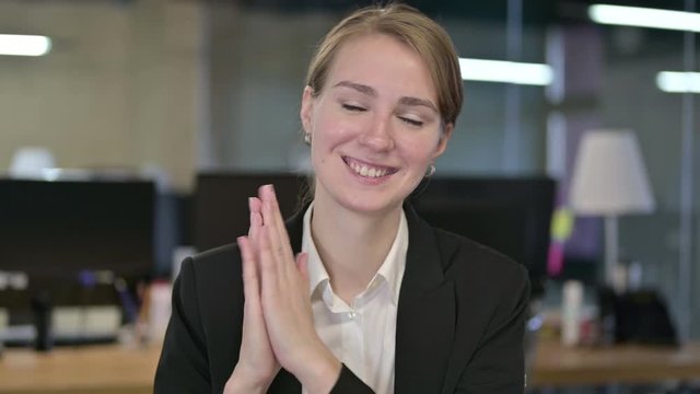 Portrait of Happy Young Businesswoman Clapping