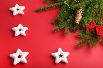red christmas background with stars and fir branches