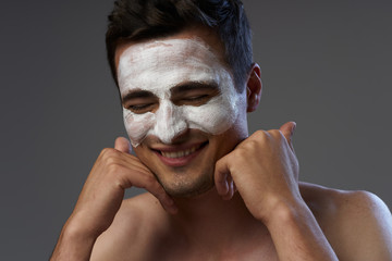 portrait of young man with facial mask on her face
