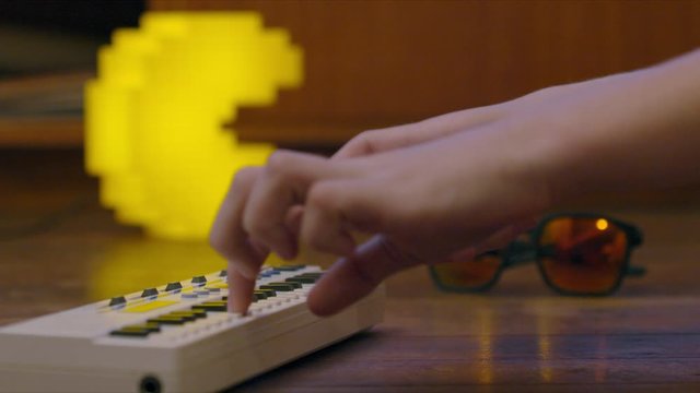 Side on view playing keyboard with game light