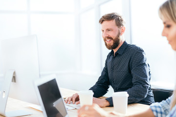 smiling businessman working on a computer in the office