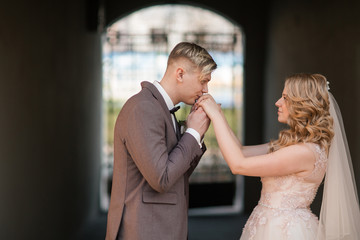 Fototapeta premium happy groom kisses the hand of the bride