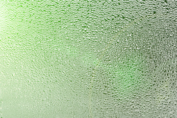 Drops of water on wet glass. Thaw, melts, ice on the window.