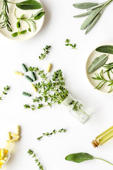 Medicine made from wildflowers and herbs with essential oils on white background top view pattern